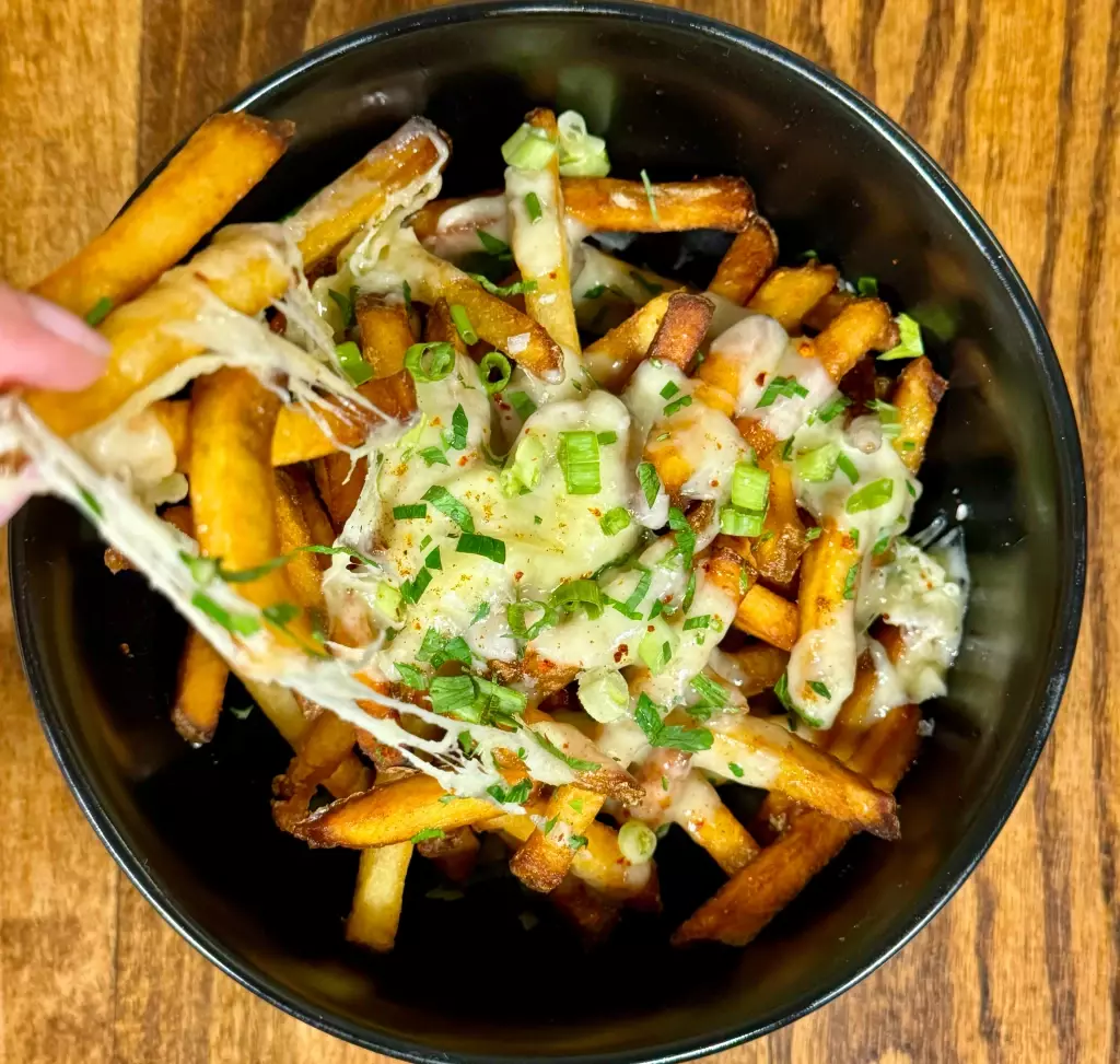 House-made fries topped with raclette cheese in Orange Beach, Alabama