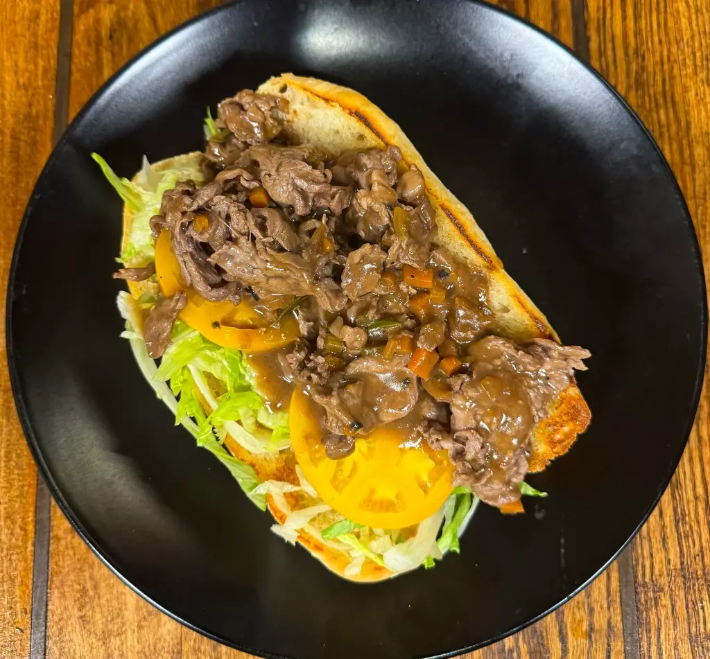 Po'Boy filled with chef-selected, seasonal ingredients, and toppings. Best Po'Boy in Orange Beach