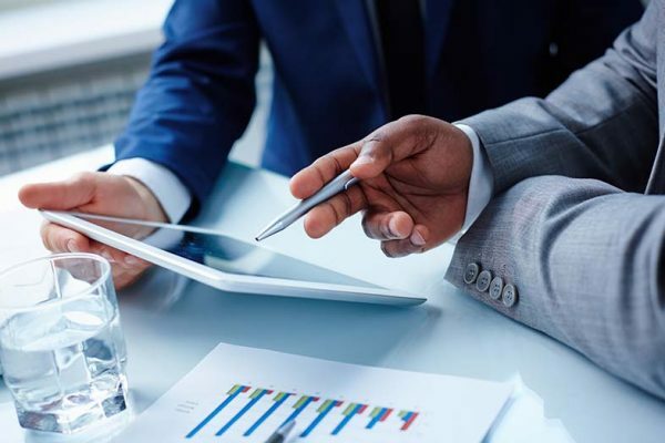 2 people going over finances on a tablet